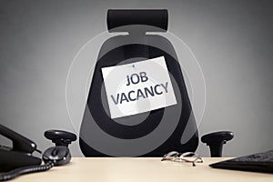 Office chair with job vacancy sign