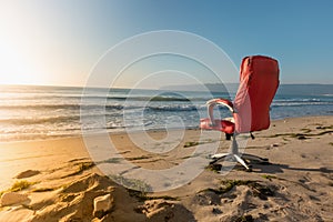 Office chair on sandy beach