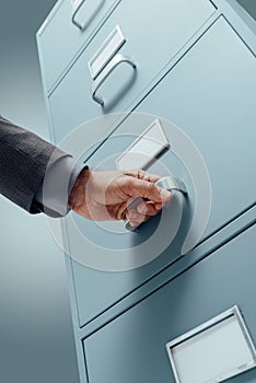 Office clerk searching files in the filing cabinet