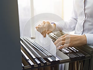 Office clerk searching files in the filing cabinet