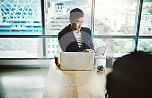 The office with a collaborative culture. two young businessmen working together at a desk in a modern office.