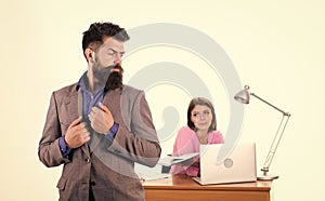 Office collective concept. Working together. Manager boss stand in front of girl busy with laptop. Office manager or