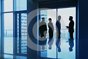 Office concept with employees silhouettes against big window