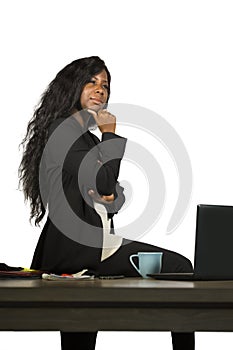 Office corporate company portrait of young happy and attractive black African American businesswoman standing at her computer desk