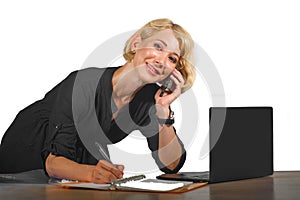 Office corporate portrait of young beautiful and happy business woman working relaxed at laptop computer desk smiling confident in