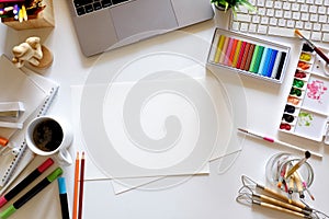 Office dark white desk table with computer, designer supplies and coffee mug. Top view workspace and copy space