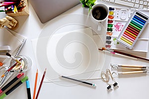 Office dark white desk table with computer, designer supplies and coffee mug. Top view workspace and copy space