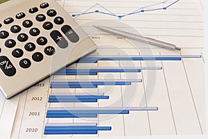 Office desk with charts , histograms and financial documents