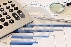 Office desk with charts , histograms and financial documents