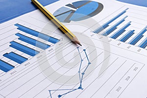 Office desk with charts , histograms and financial documents