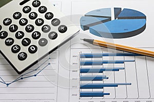 Office desk with charts , histograms and financial documents