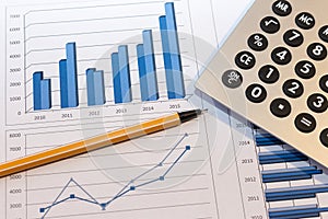 Office desk with charts , histograms and financial documents