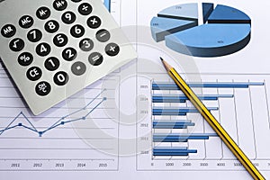 Office desk with charts , histograms and financial documents
