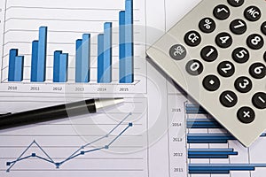 Office desk with charts , histograms and financial documents