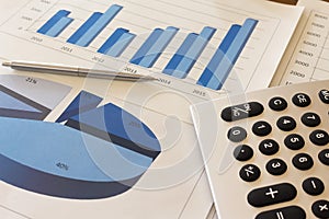 Office desk with charts , histograms and financial documents