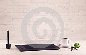 Office desk closeup with white brick wall