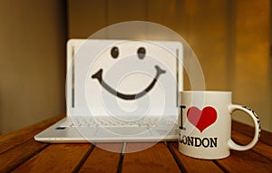 Office desk with computer; coffee cup and smile