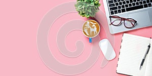 Office desk with computer, Pen, eyeglass, mouse, notebook, Cup of coffee on pink background, Top view