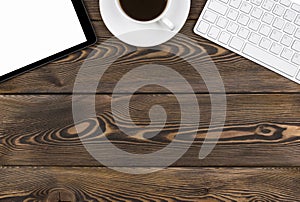 Office desk with copy space. Digital devices wireless keyboard, mouse and tablet computer with empty screen on dark wooden table