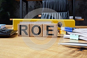 Office desk and cubes with ROE Return on Equity.