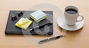 Office Desk Essentials: Coffee, Notebook, and Stationery