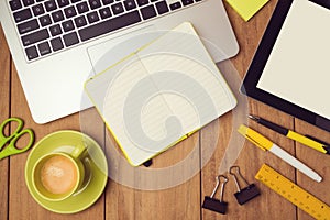 Office desk mock up template with laptop, notebook and tablet. View from above