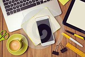 Office desk mock up template with laptop and smart phone. View from above