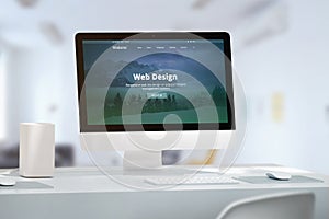 Office desk with modern computer monitor and responsive web site off web design studio