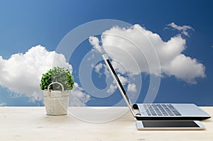 Office Desk with Notebook, tablet , small tree on basket and Blu