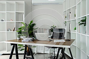 Office desk with office equipment provide fresh air environment, work area, and photocopying area