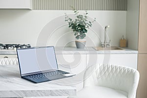 Office desk scenery with mockup blank screen laptop computer. Workspace minimal