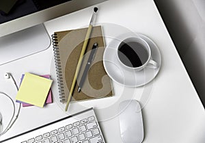 Office desk with stationaries and coffee cup