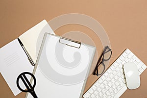 Office desk table with clipboard keyboard notebook glasses and scissors. Mock up template . Top view.- Image
