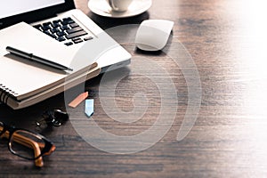 Office desk table with computer, eyeglass, white mouse, silver p