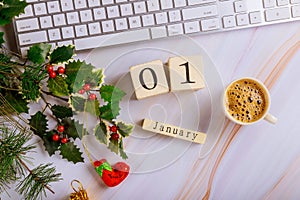 Office desk table with computer keyboard and coffee cup with decorated christmas tree top view copy space 1 January New Year Day