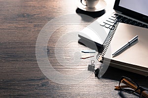 Office desk table with computer, silver pen and black coffee cup