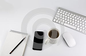 Office desk table with computer, Smartphone, note pad, pencils,