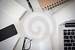 Office desk table with computer, supplies, flower and coffee cup