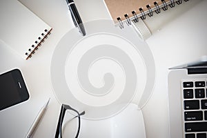 Office desk table with computer, supplies, flower and coffee cup