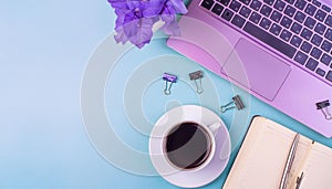 Office desk table with computer, supplies, flower and coffee cup. Top view with copy space