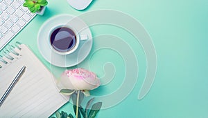 Office desk table with computer, supplies, flower and coffee cup. Top view with copy space