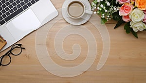 Office desk table with computer, supplies, flower and coffee cup. Top view with copy space