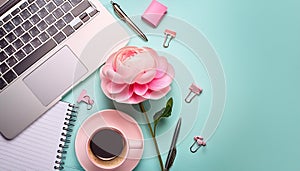 Office desk table with computer, supplies, flower and coffee cup. Top view with copy space