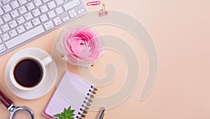 Office desk table with computer, supplies, flower and coffee cup. Top view with copy space