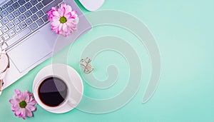 Office desk table with computer, supplies, flower and coffee cup. Top view with copy space