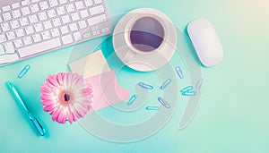 Office desk table with computer, supplies, flower and coffee cup. Top view with copy space