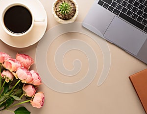 Office desk table with computer, supplies, flower and coffee cup. Top view with copy space