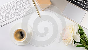 Office desk table with computer, supplies, flower and coffee cup. Top view with copy space