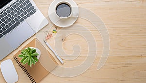 Office desk table with computer, supplies, flower and coffee cup. Top view with copy space