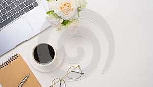 Office desk table with computer, supplies, flower and coffee cup. Top view with copy space